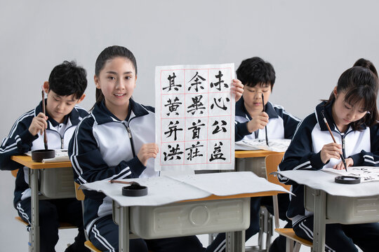 Students practicing calligraphy in classroom