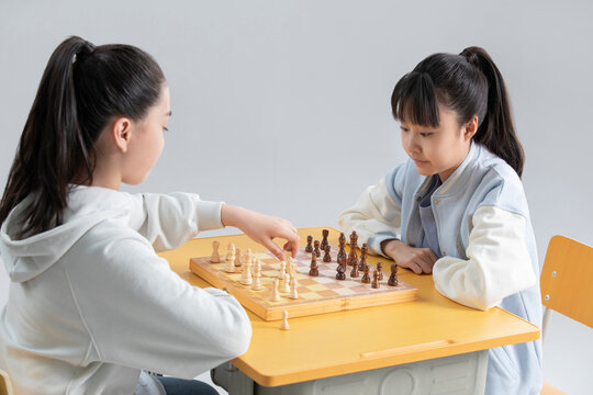Two girls playing chess