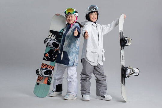 Cheerful girl and boy with snowboards