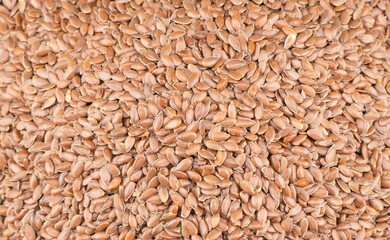 Fototapeta premium Linseeds. Flax seeds texture background. Flax seed heap background. Linseed pile closeup