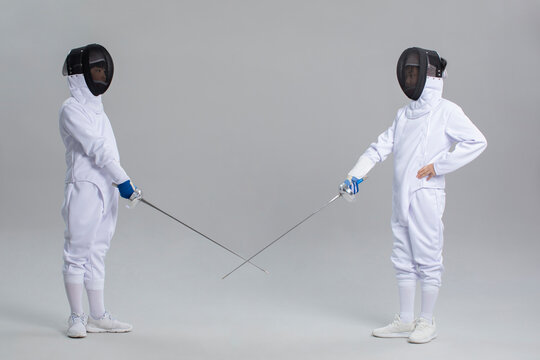 Cute boys in fencing suit