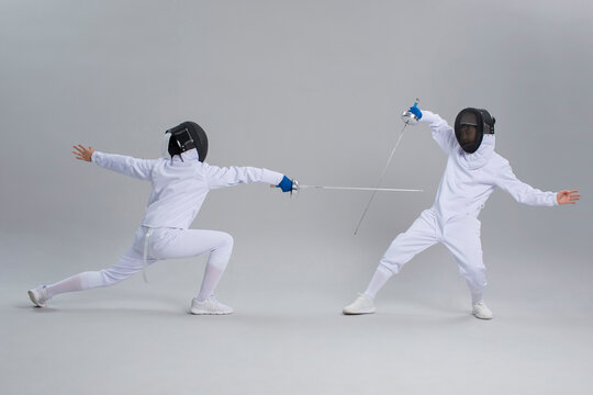 Cute boys in fencing suit