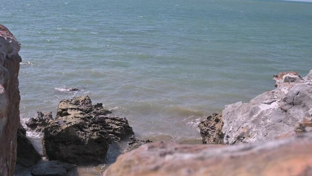 small waves gently rolling into rock formations on the Northern Edge of Australia, at Nightcliff in Darwin