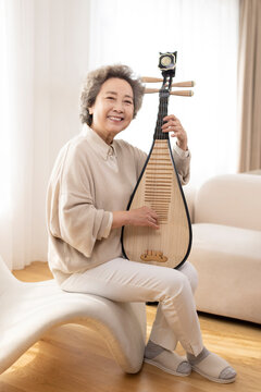 Senior woman plucking Chinese lute