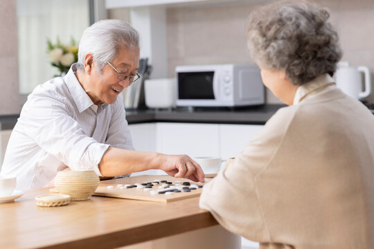 Senior couple  playing the game of go at home