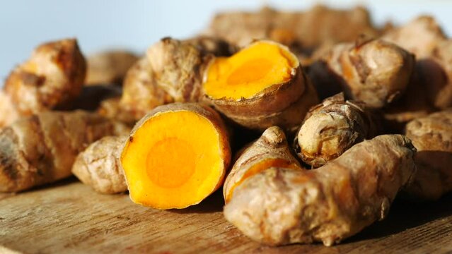 detail shot of turmeric root in bowl on table ,