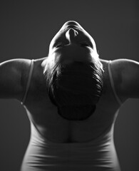 Dance, ballet and monochrome with a woman in studio on a dark background for creative, art or expression. Theatre, broadway or performance with a young female ballerina or dancer in black and white