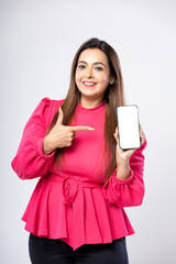 Indian woman showing smartphone screen on white background.