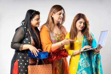 Indian women group using laptop while shopping. online shopping concept.
