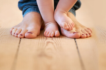 Closeup, feet and mother with baby in their home for walking, learning and love, bonding and...