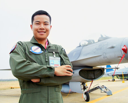 Portrait of asian man, fighter pilot with jet and confident smile at airforce base with arms crossed in Korea. Freedom, transport and proud Asian soldier with airplane, confident and service in army.