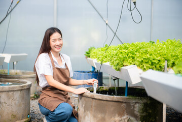 Researcher in uniform are checking with ph strips in hydroponic farm and pH level scale graphic,...