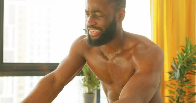 tired exhausted African American man wiping his sweat from forehead during workout at home fitness health body care endurance motivation tiredness Slow motion