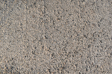 Dirty old asphalt floor in the sun. Rough and grunge wall texture background. 