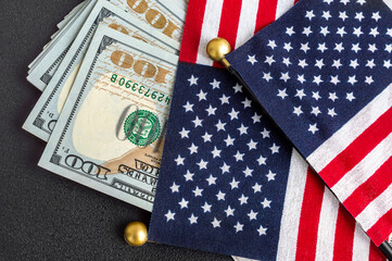 American flags with dollar bills on black background. - obrazy, fototapety, plakaty