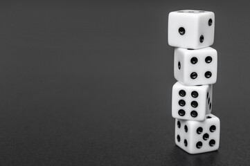 Stack of dices on black. Space for text.