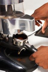 Barista hands, cafe and espresso with coffee machine for service with brewing process in closeup. Restaurant, hot beverage and hand with person working for preparation with premium caffeine blend.