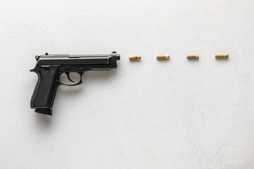 Composition with gun and cigarette filters on light background. Stop smoking concept