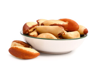 Bowl of delicious Brazil nuts on white background