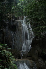 Beautiful waterfall surrounded by lush green trees. Serene and peaceful atmosphere for relaxation in nature