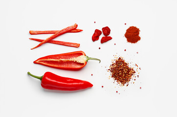Composition with fresh chili peppers, powder and flakes on light background