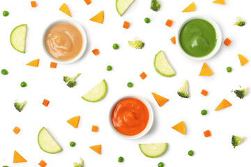 Composition with bowls of healthy baby food and fresh vegetables on white background