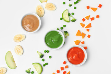 Composition with bowls of healthy baby puree and ingredients on white background