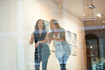Women, friends together and exhibition at gallery, conversation and culture appreciation. Woman,...