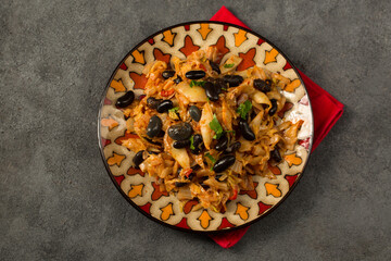Cabbage and black bean stew on a plate, top view