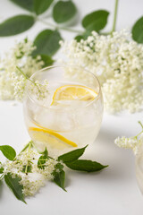 A delicious cold summer drink made of elderflowers and lemon with ice