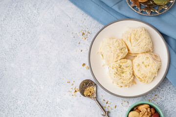 Plate with tasty Turkish Pismaniye on light background