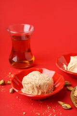 Bowl with tasty Turkish Pismaniye on red background