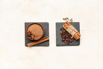 Composition with bowl of cinnamon powder, sticks and coffee beans on light background