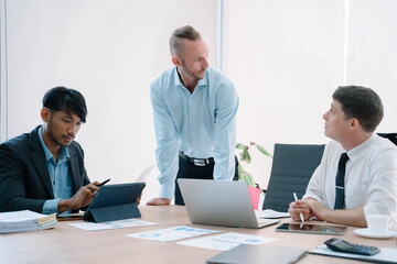 Fototapeta premium Group of diverse business people discussing a project in a meeting for analysis graph company financial.