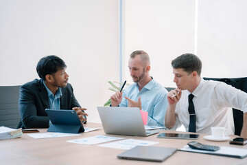 Fototapeta premium Group of diverse business people discussing a project in a meeting for analysis graph company financial.