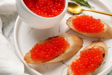 Tasty bruschettas with red caviar on grunge background