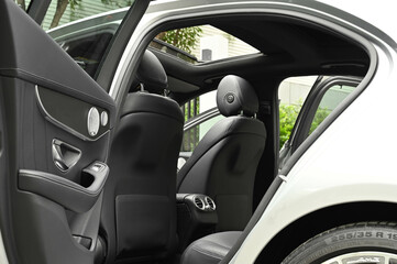 The rear passenger seat is wide and clean. Leather interior, side view, solar sunroof, buttons, Nappa leather, beige,black