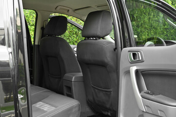 The rear passenger seat is wide and clean. Leather interior, side view, solar sunroof, buttons, Nappa leather, beige,black