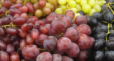 Different kinds of grapes close-up. Assortment of grape as background.	