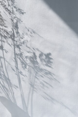Beautiful lifestyle sunlight shadow of meadow grass on light blue pastel linen texture curtain...