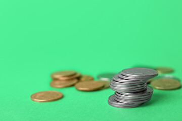 Stack of coins on green background