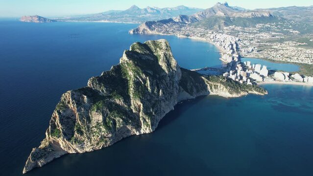 Aerial fly over view of the beautiful city of Calp in Spain with Pe&ntilde;&oacute;n de Ifach Parc Natural