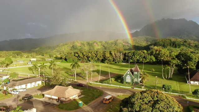 Aerial view of a pair of rainbows from over the historic Waiʻoli Huiʻia Church in the town of Hanalei, on the Hawaiian island of Kauai
