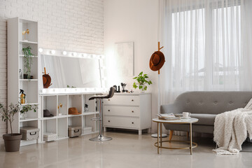 Interior of beauty salon with mirror and chest of drawers