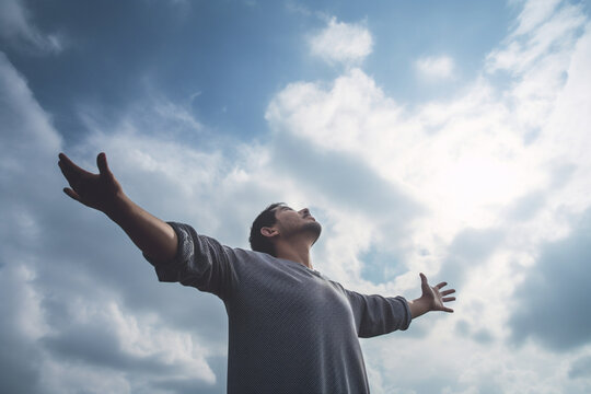 unrecognizable Man feeling free looking up to the sky