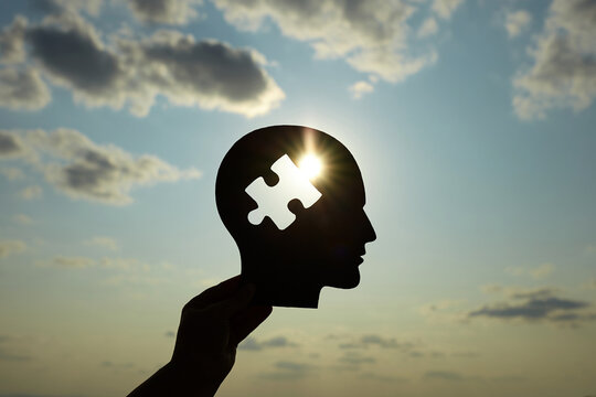 Concept of a human head with a puzzle in the middle