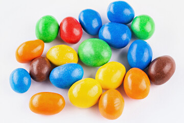 Fototapeta na wymiar Chocolate coated Peanuts. Colorful chocolate buttons, on white background.