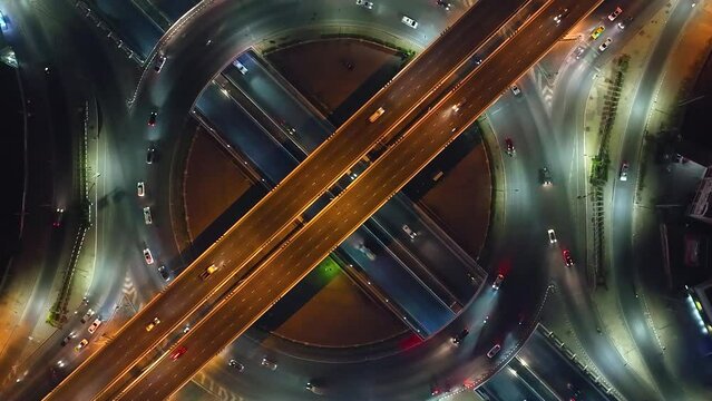 Expressway top view, Road traffic an important infrastructure, car traffic transportation above intersection road in city night, aerial view cityscape of advanced innovation, financial technology	