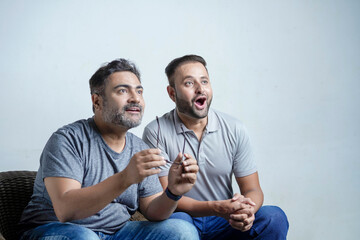 Father and son watching some and giving face expression on white background.