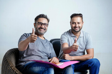 Two indian man showing thumps up on white background